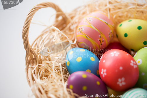 Image of close up of colored easter eggs in basket