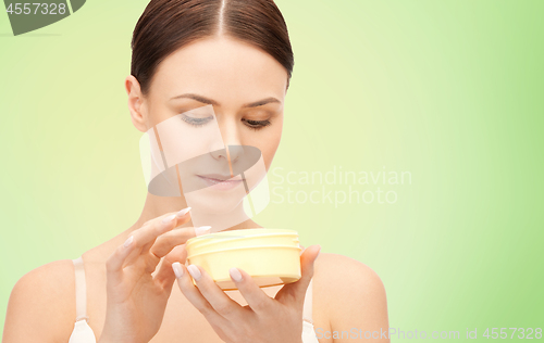 Image of beautiful woman with moisturizing cream