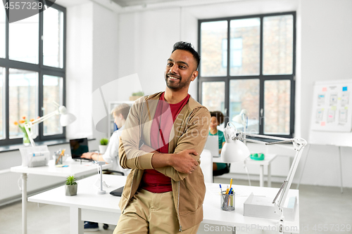 Image of smiling indian man at office