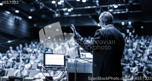 Image of Public speaker giving talk at Business Event.