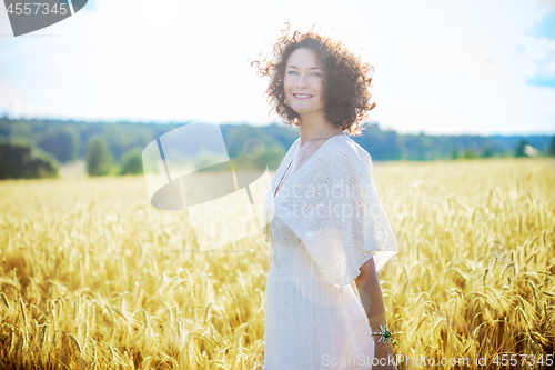 Image of beautiful smiling woman in a white dress
