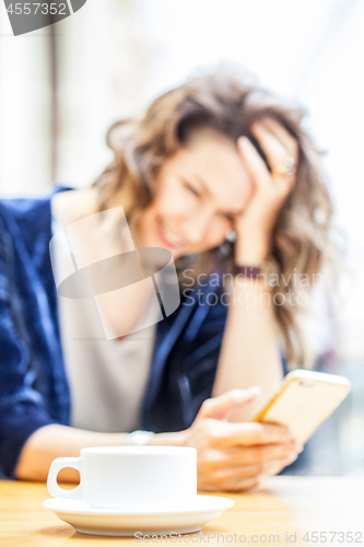 Image of coffee cup and a laughing woman