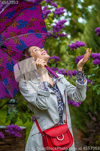 Image of beautiful middle-aged woman with an umbrella