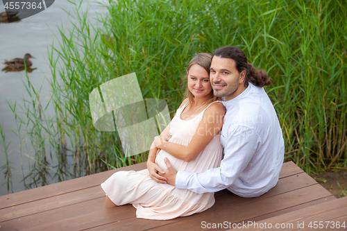 Image of Happy couple resting by the lake