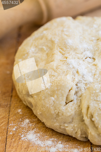 Image of Fresh raw yeast dough with rolling pin