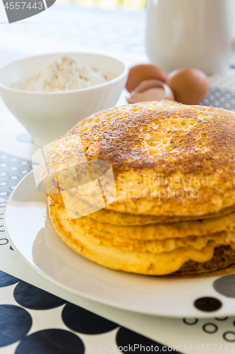 Image of Stack of pancakes with baking ingredients