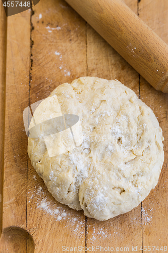 Image of Fresh raw yeast dough with rolling pin