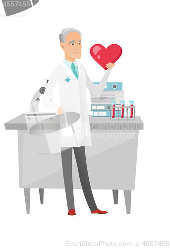 Image of Caucasian cardiologist holding a big red heart.