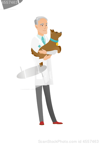 Image of Senior caucasian veterinarian with dog in hands.
