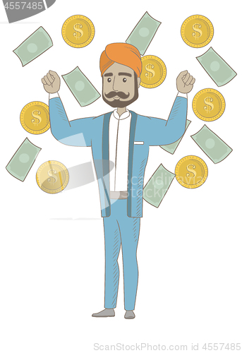 Image of Happy hindu busiessman standing under money rain.
