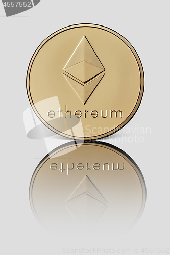 Image of Gold coin ethereum represented on a white glossy background