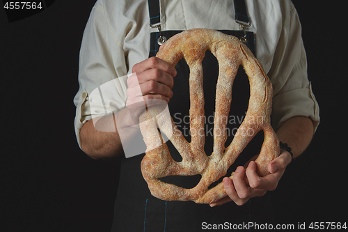 Image of Baker\'s hands hold fougas bread