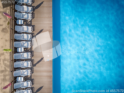 Image of Beach chairs near swimming pool, top view
