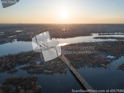 Image of North bridge over the Dnieper River overlooking the Skaimol shopping center and Obolon district on the sunset