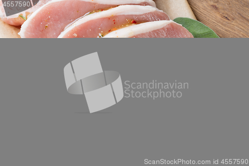 Image of raw pork escalope with sause made of honey and herbs