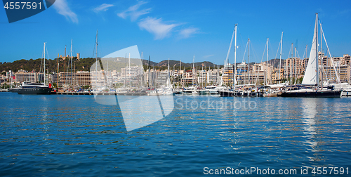 Image of boats in clear blue water of bright summer day.