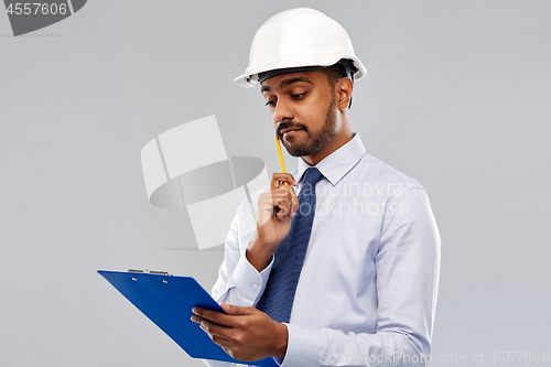 Image of architect or businessman in helmet with clipboard