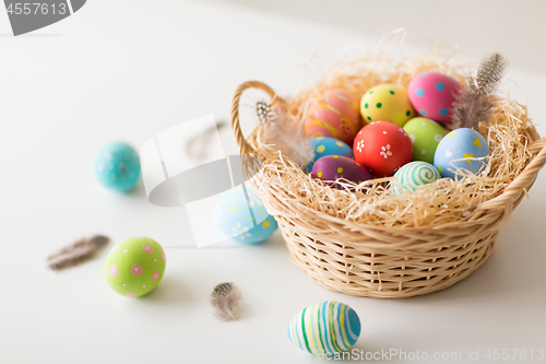 Image of close up of colored easter eggs in basket