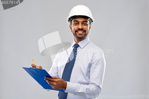 Image of architect or businessman in helmet with clipboard