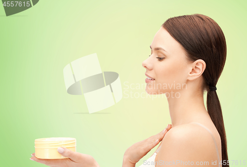 Image of beautiful woman with moisturizing cream