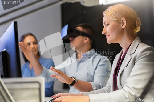 Image of business team with computer working late at office