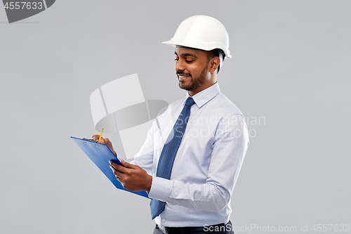 Image of architect or businessman in helmet with clipboard