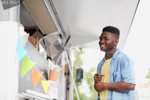 Image of male customer looking at billboard at food truck