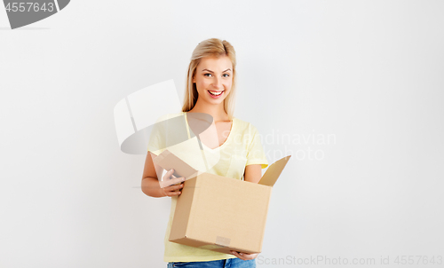 Image of happy woman holding cardboard box