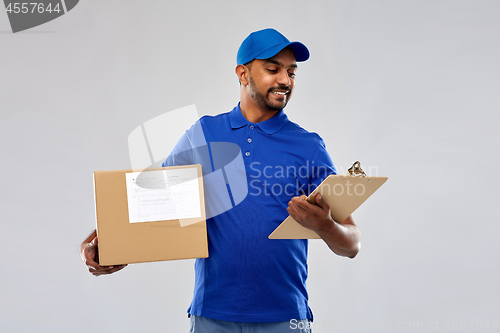 Image of indian delivery man with parcel box and clipboard