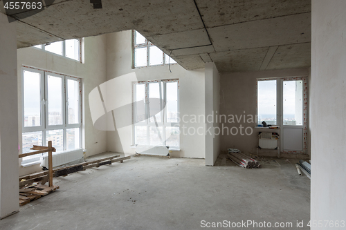 Image of Living room in a new building, with large stained glass windows and a second light