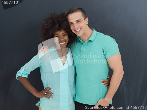 Image of multiethnic couple in front of gray chalkboard