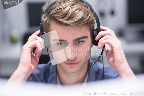 Image of male call centre operator doing his job