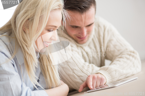 Image of Young Couple using digital tablet on cold winter day