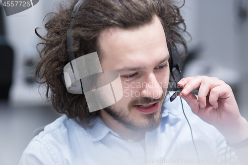 Image of male call centre operator doing his job