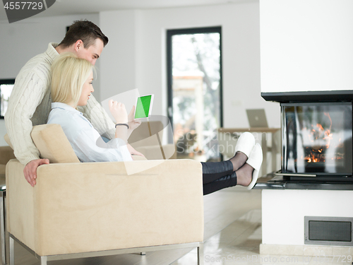 Image of Couple using digital tablet on cold winter day