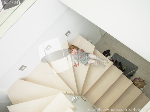 Image of little cute girl enjoying on the stairs