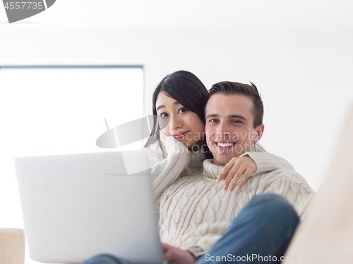 Image of multiethnic couple using laptop computers