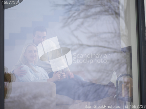 Image of Couple using digital tablet on cold winter day