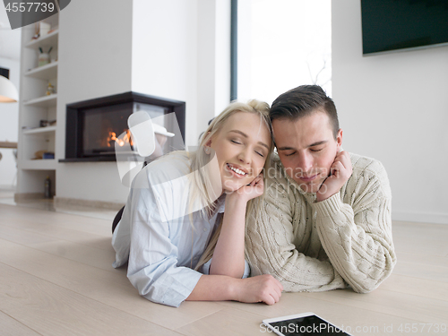 Image of Young Couple using digital tablet on cold winter day