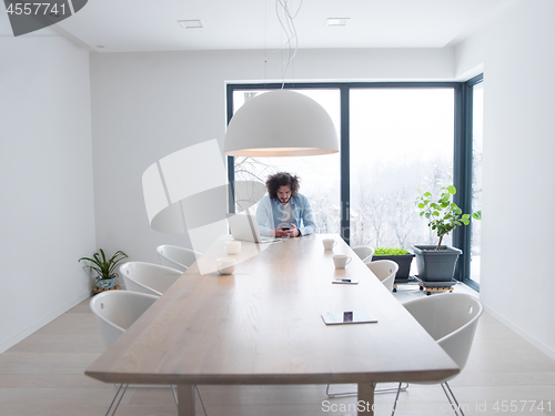 Image of man using a mobile phone  at home