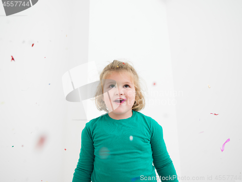 Image of kid blowing confetti