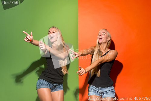 Image of The happy women point you and want you, half length closeup portrait