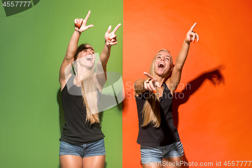 Image of The happy women point you and want you, half length closeup portrait