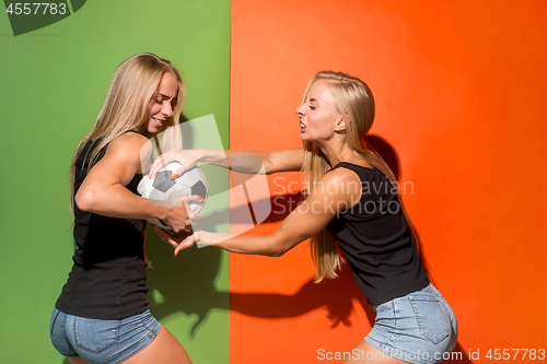 Image of Fan sport woman player holding soccer ball