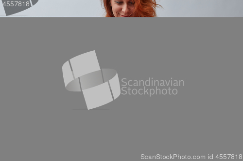 Image of Vase with a bouquet of pink roses. Woman holding a vase of flowe