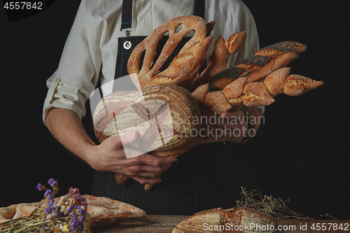 Image of Variety of bread hold men\'s hands