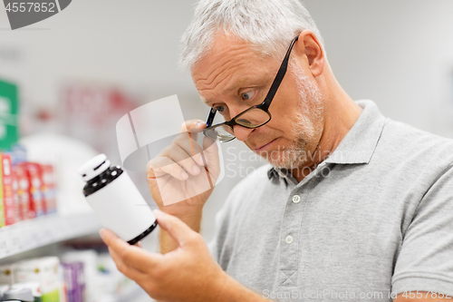 Image of senior male customer with drug at pharmacy