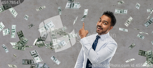 Image of indian businessman pointing finger at money
