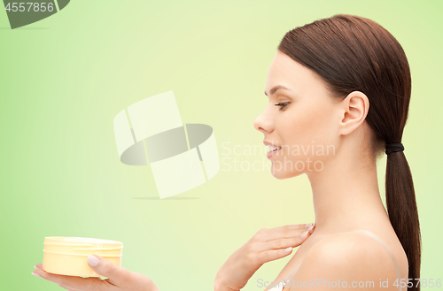 Image of beautiful woman with moisturizing cream