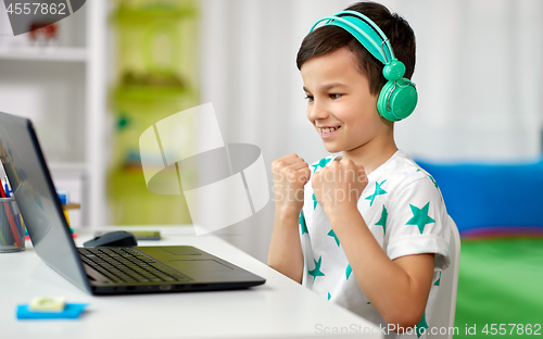 Image of boy celebrating victory in computer video game